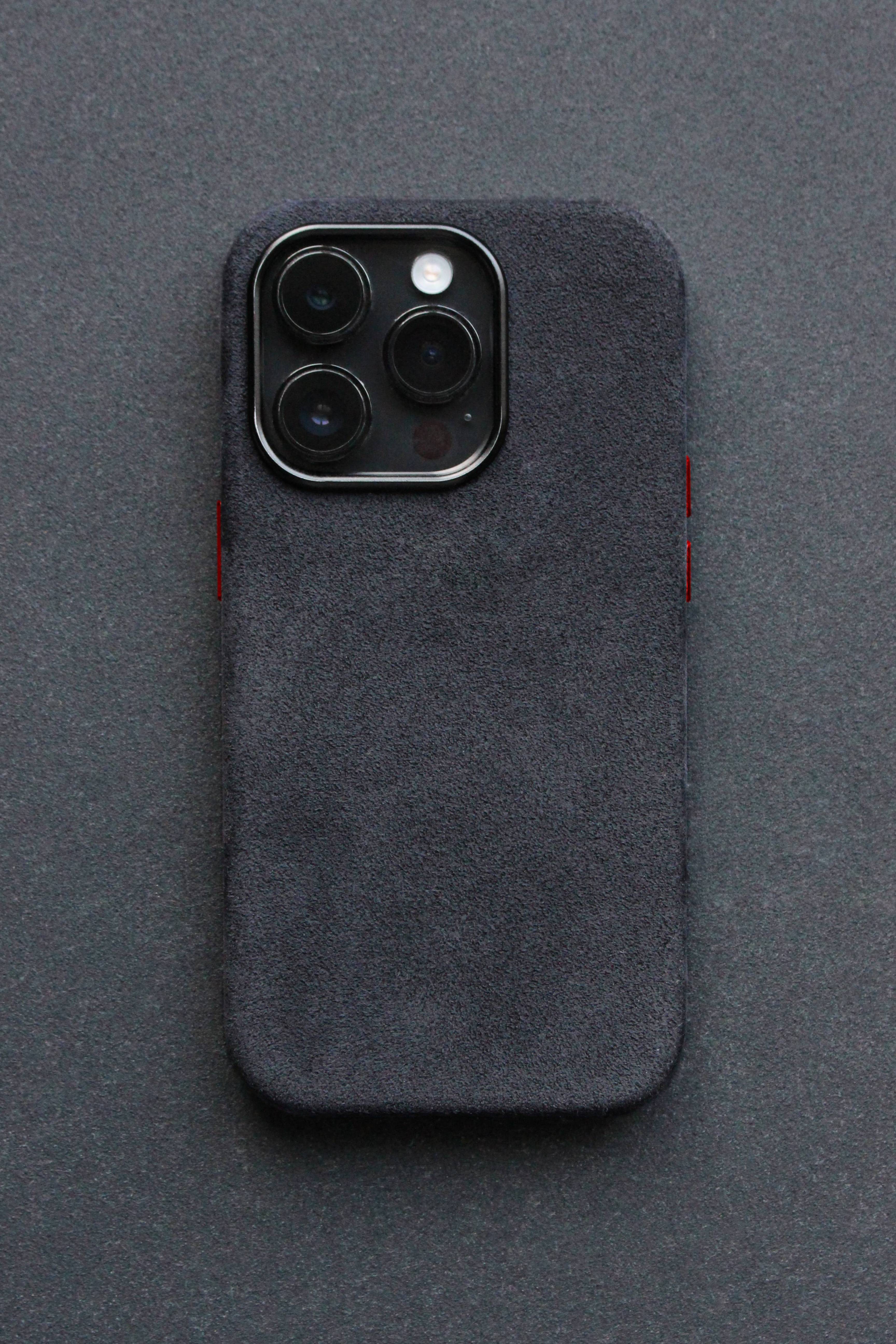 Black phone case with red accents on a gray background