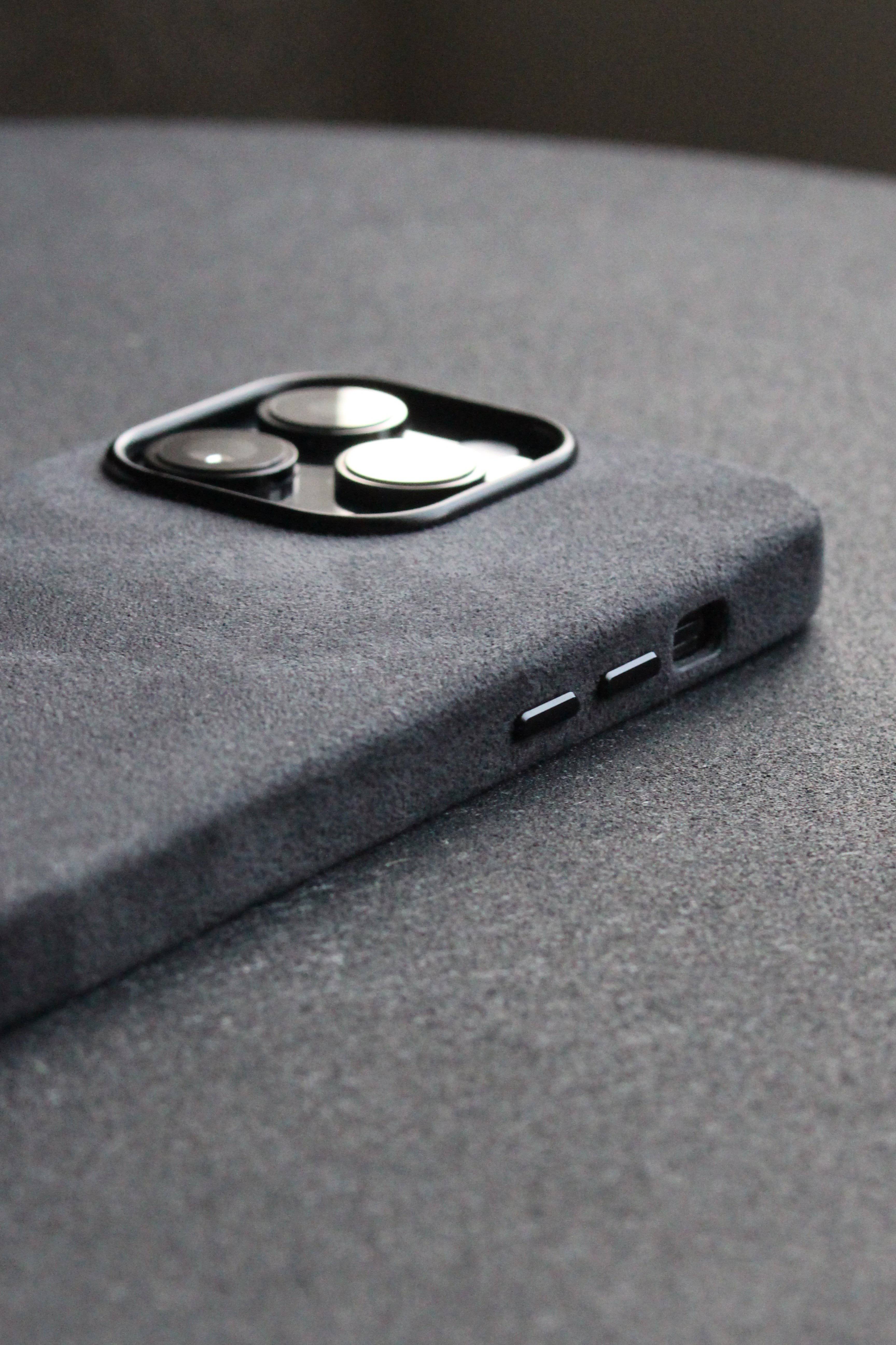 Close-up of a gray phone case on a textured surface