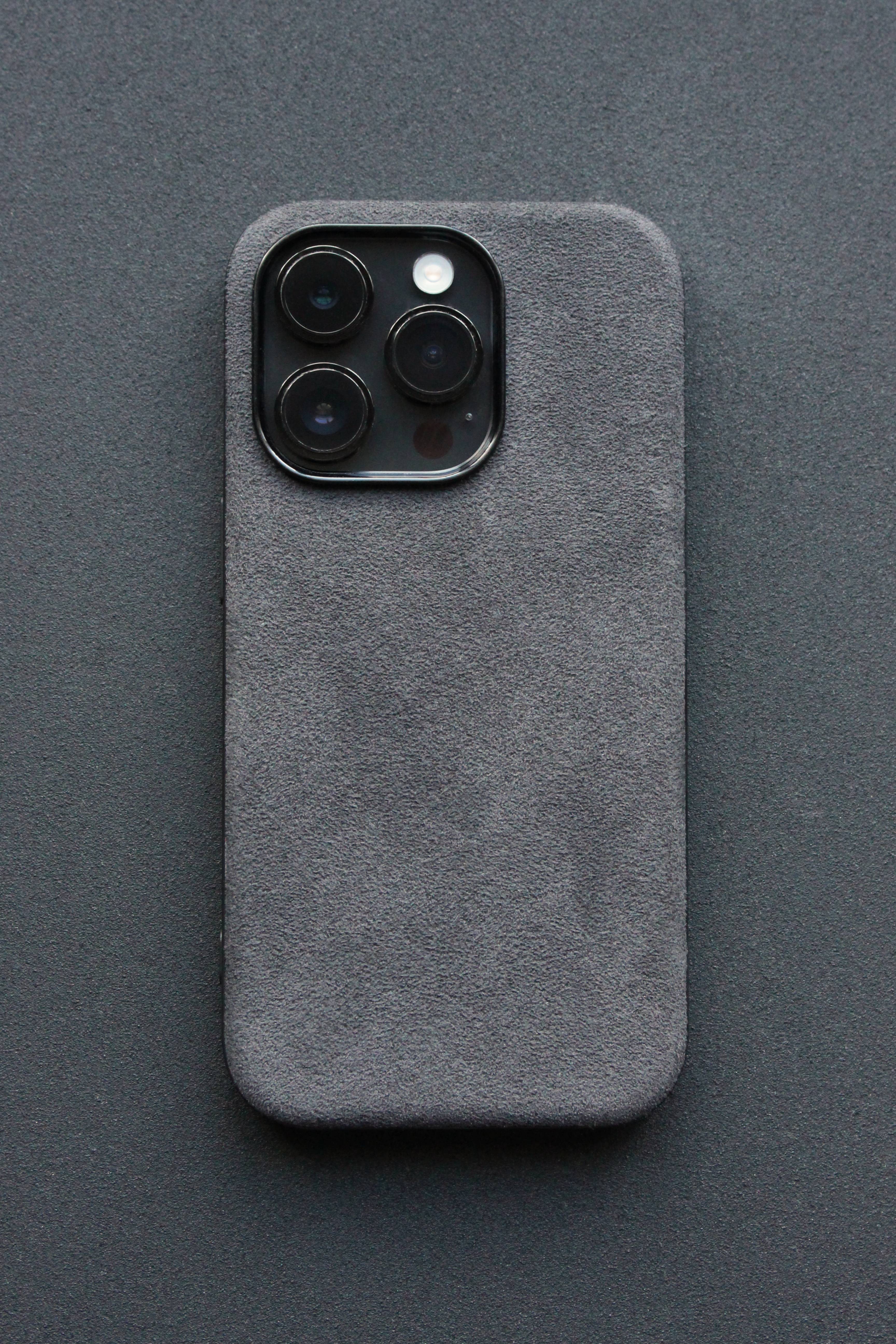 Gray phone case with a textured finish on a dark gray background