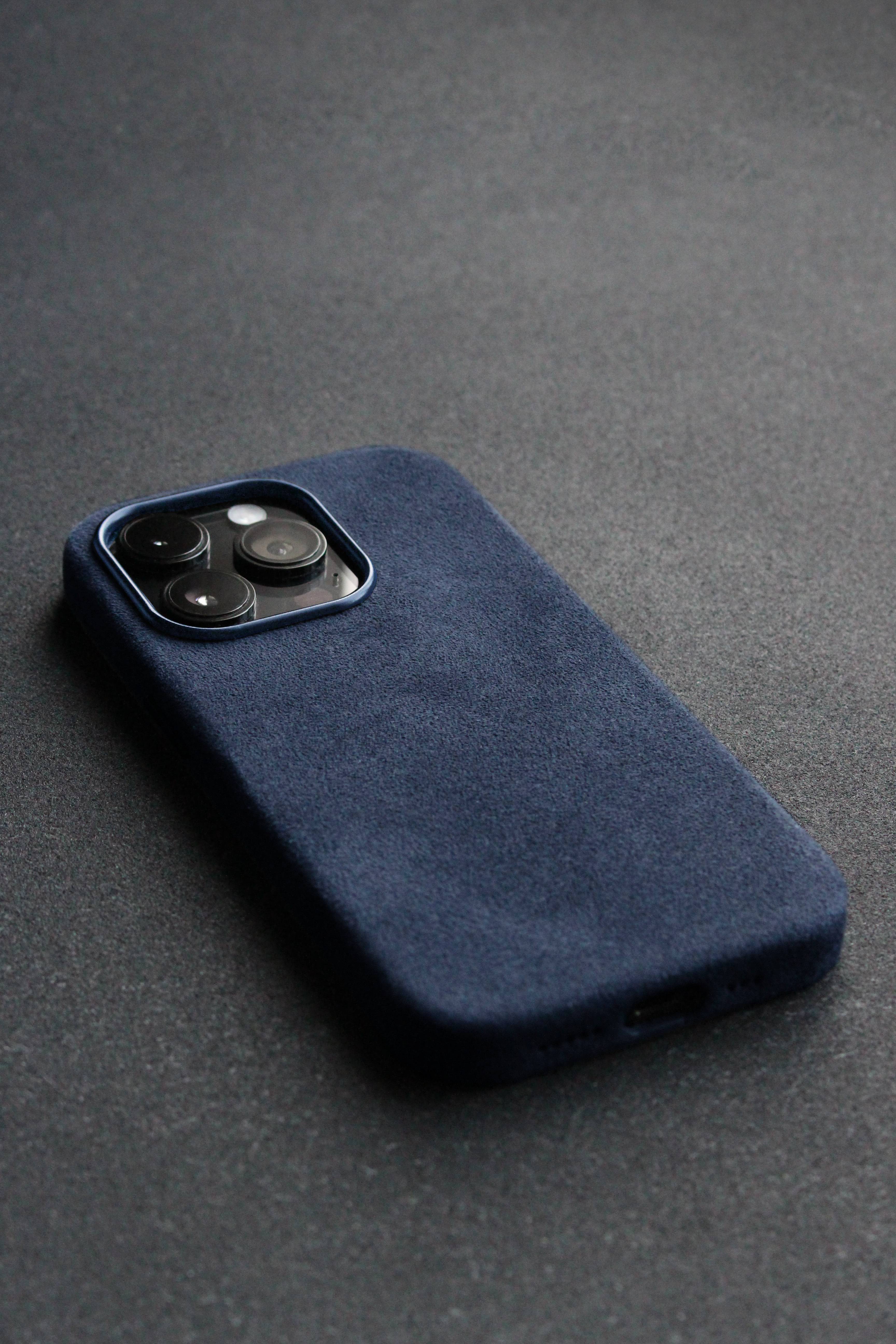 Blue phone case on a dark gray surface